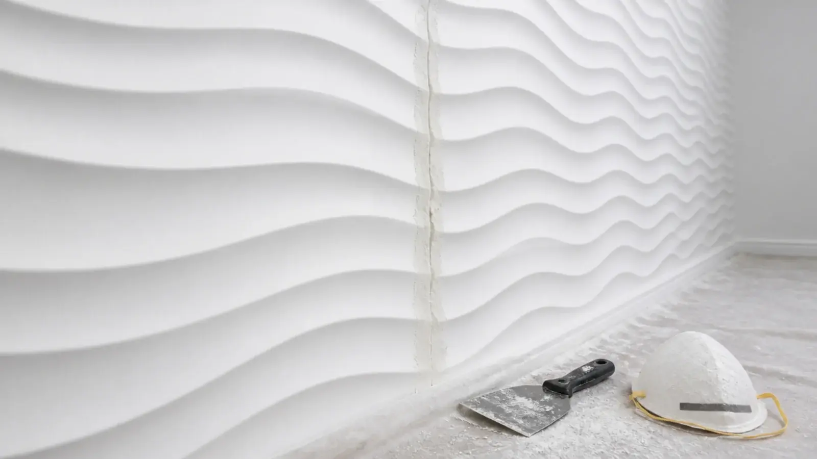 moulded gypsum panels forming a repeating relief pattern on a wall