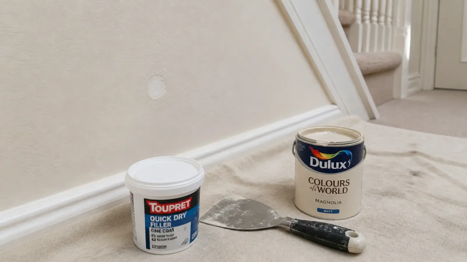 filler and a tester pot beside a patched hole on a hallway wall