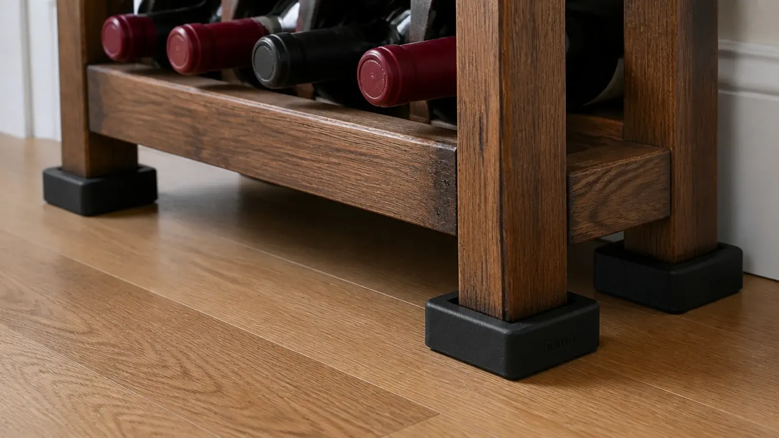 rubber isolating pads fitted beneath the feet of a wine rack