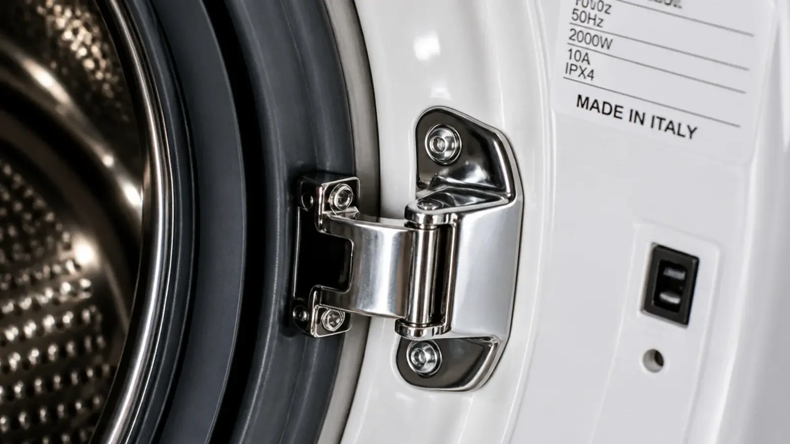 washing machine door hinge and catch shown close against white enamel