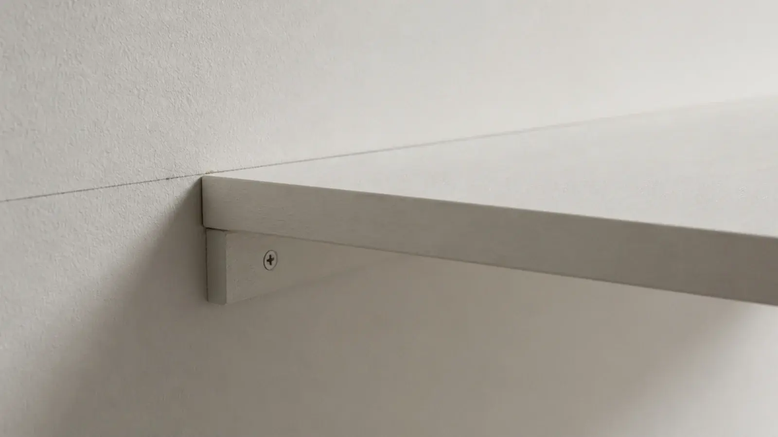 timber batten screwed along a wall carrying a shelf board without brackets