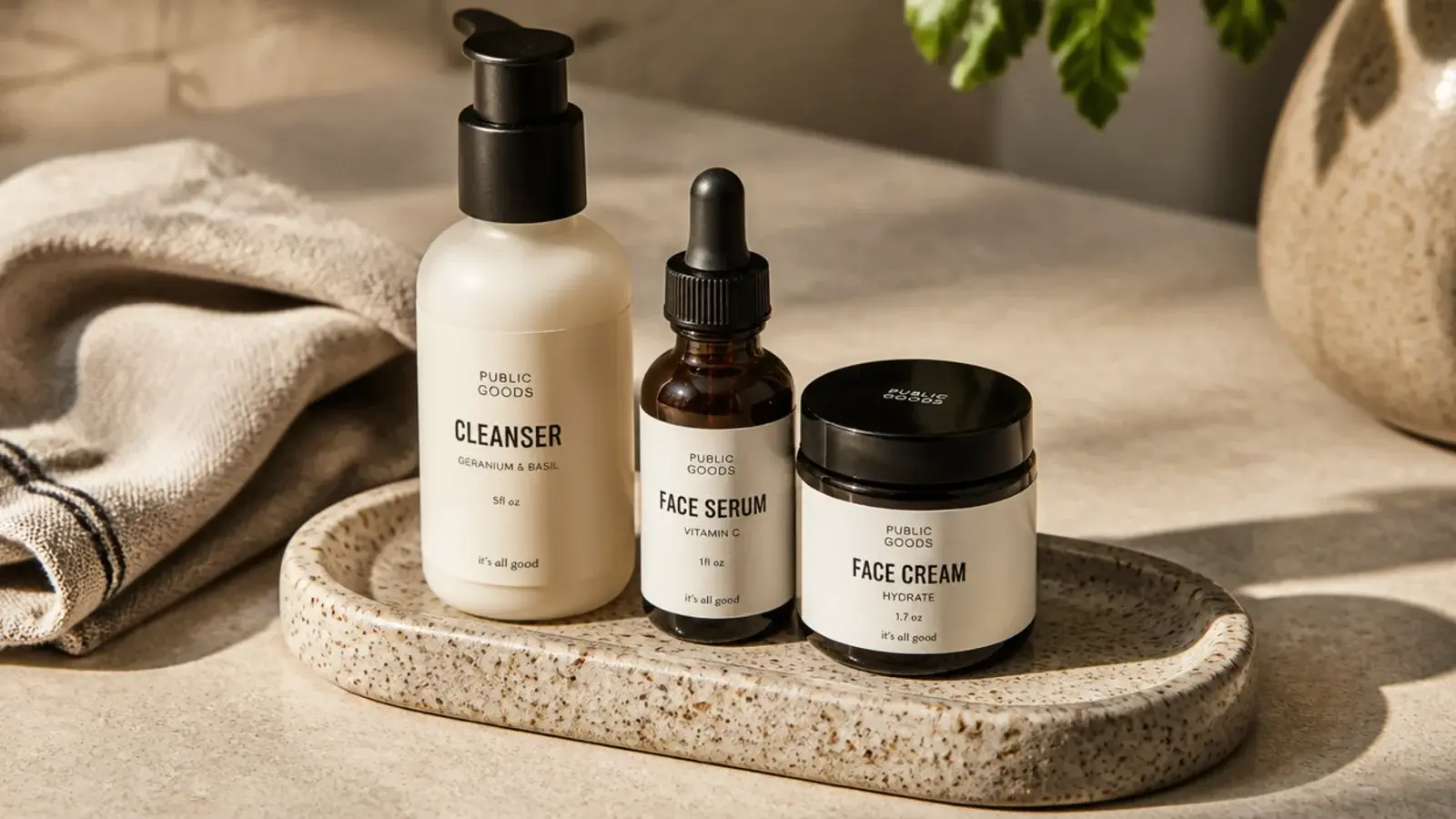 speckled stoneware tray with a raised lip holding daily skincare bottles
