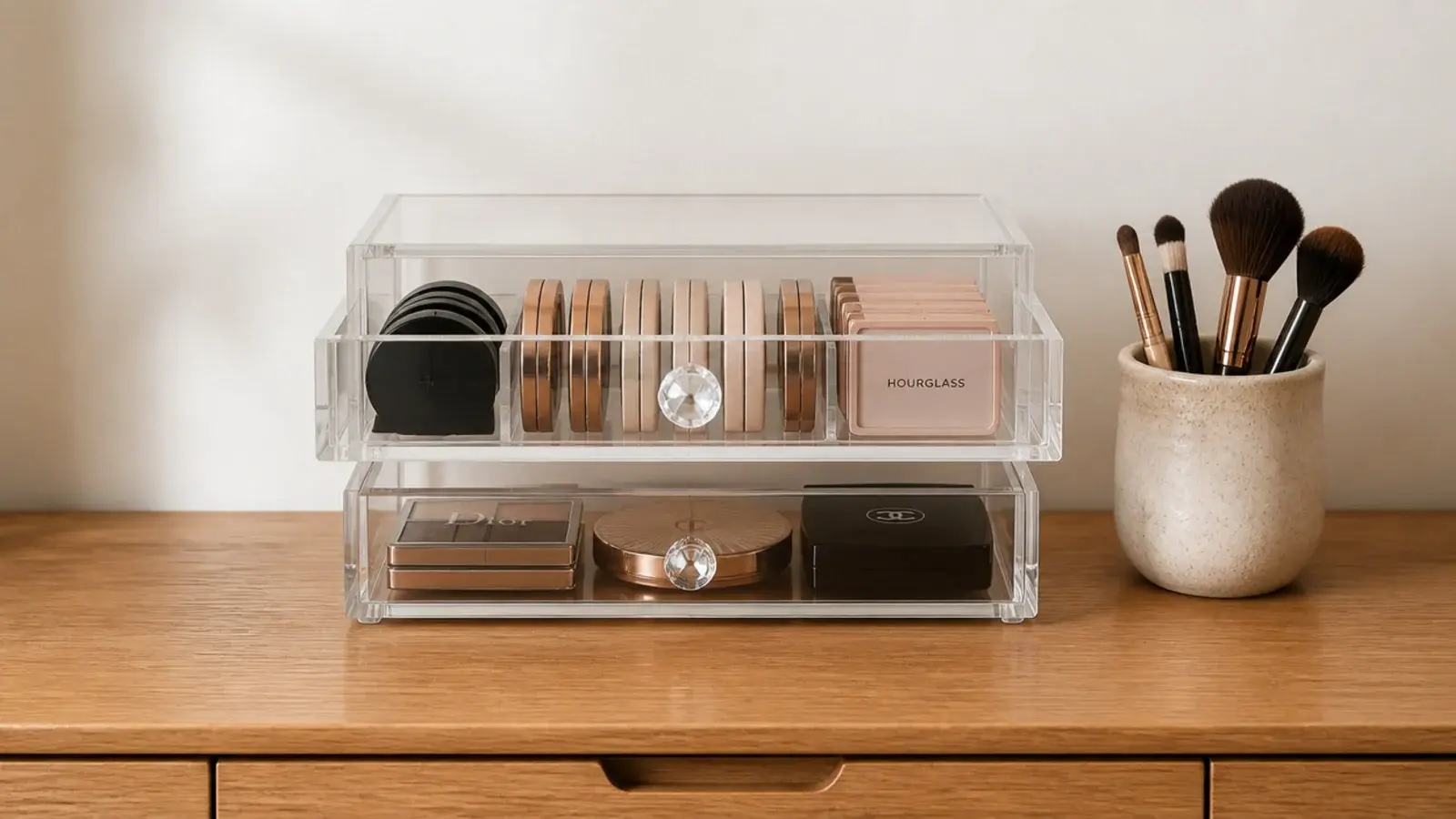 two shallow clear stacking drawers on a small vanity counter