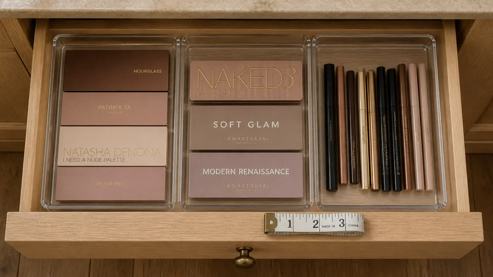clear drawer inserts fitted into a vanity drawer holding palettes upright