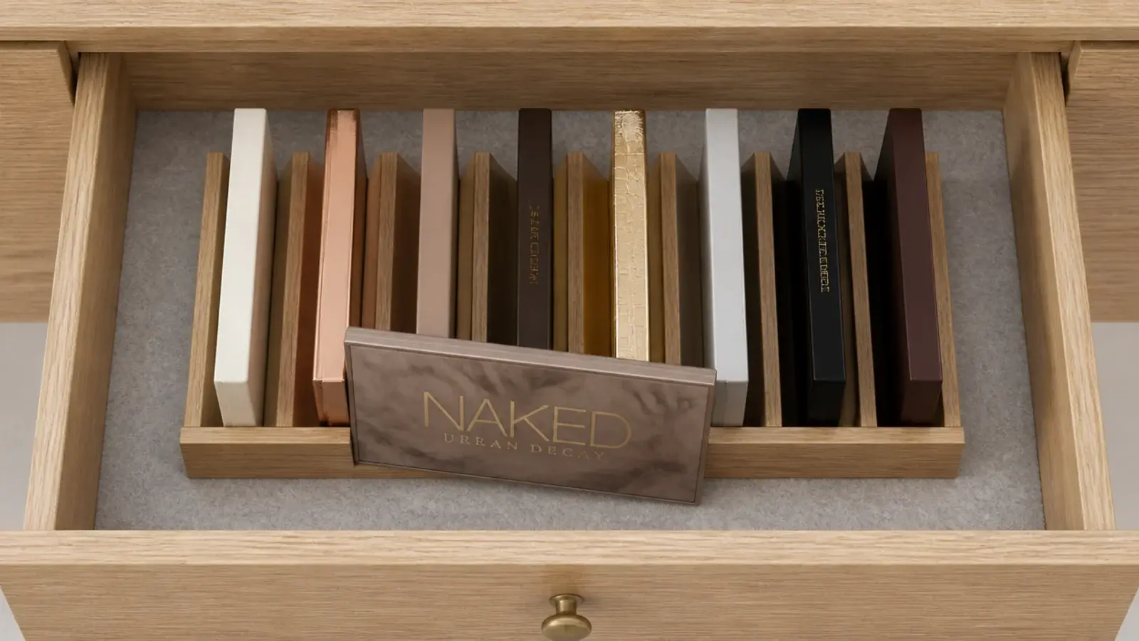 flat palettes filed upright on edge inside a shallow vanity drawer