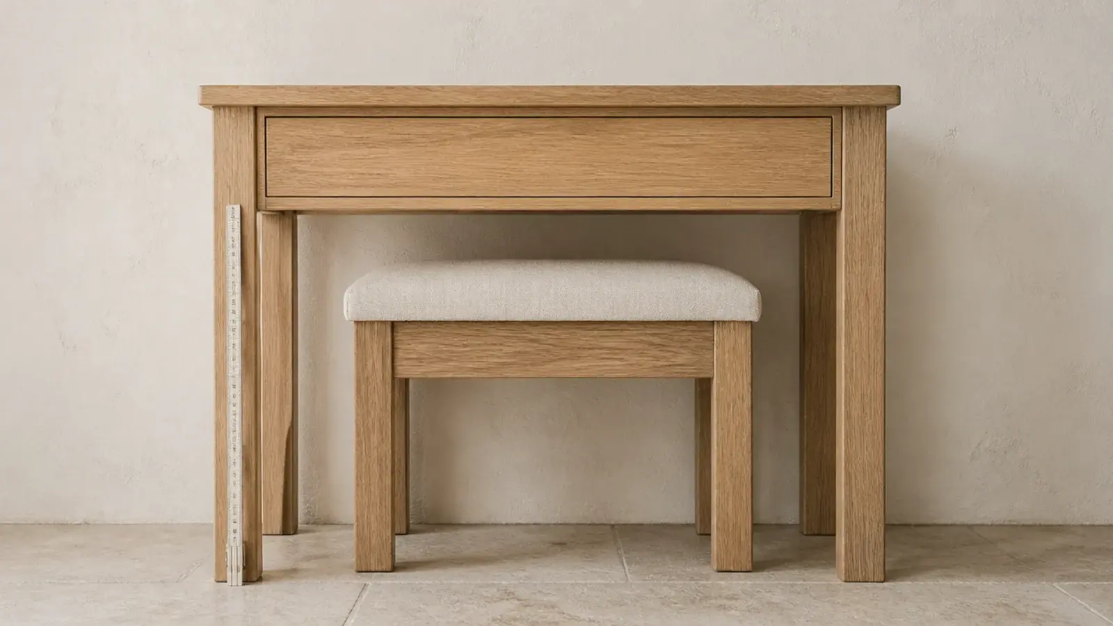 empty oak dressing table measured for height with a stool tucked beneath