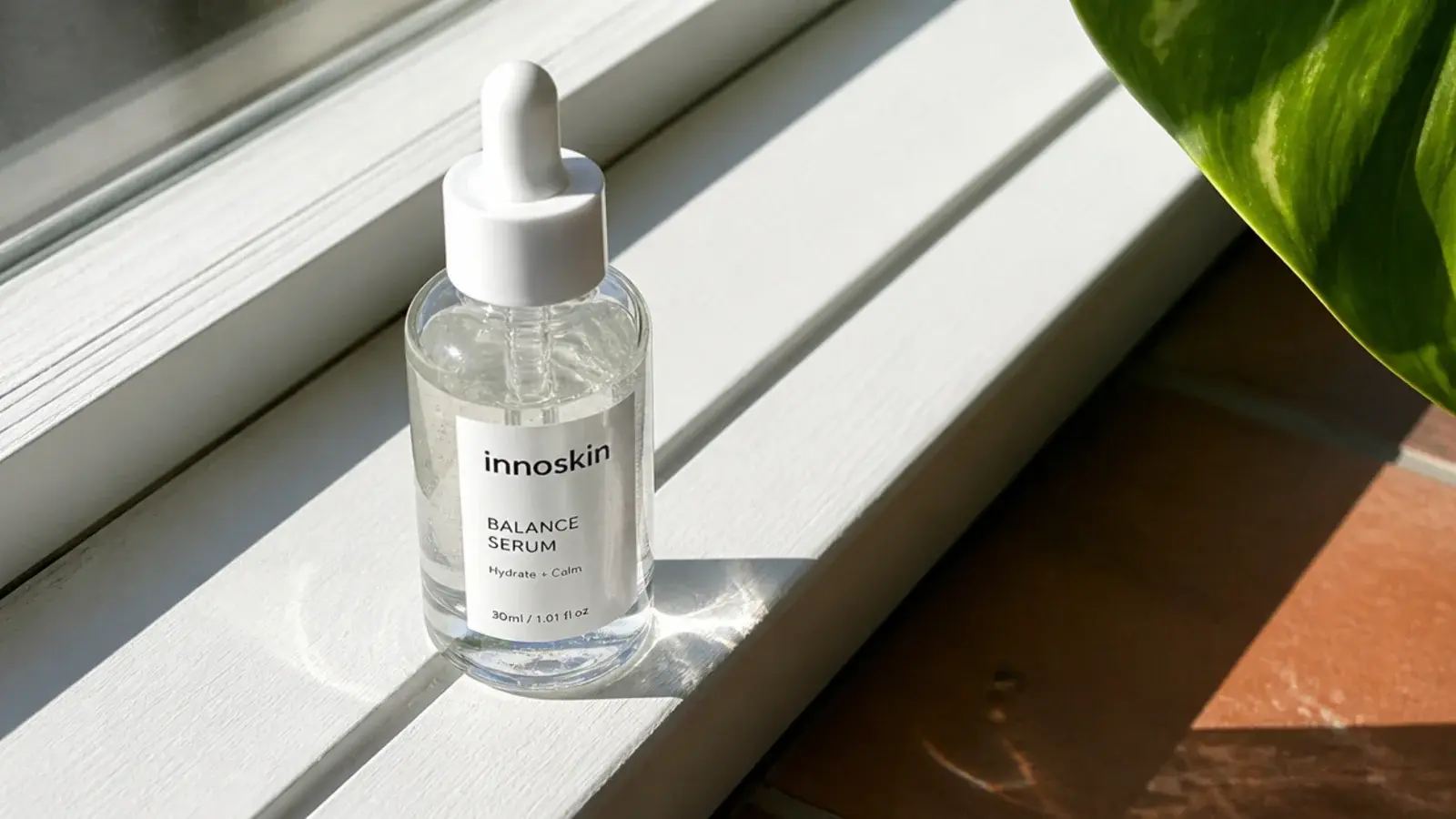 vitamin C serum sitting in direct sunlight on a bright bathroom sill