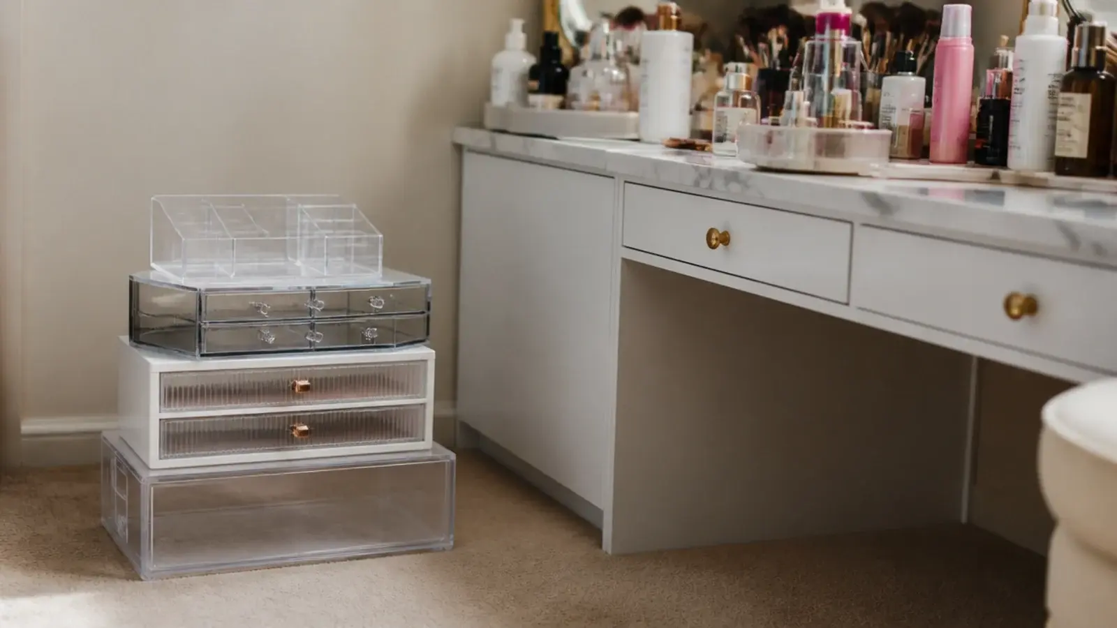 stack of unused empty organizers piled beside a still crowded vanity