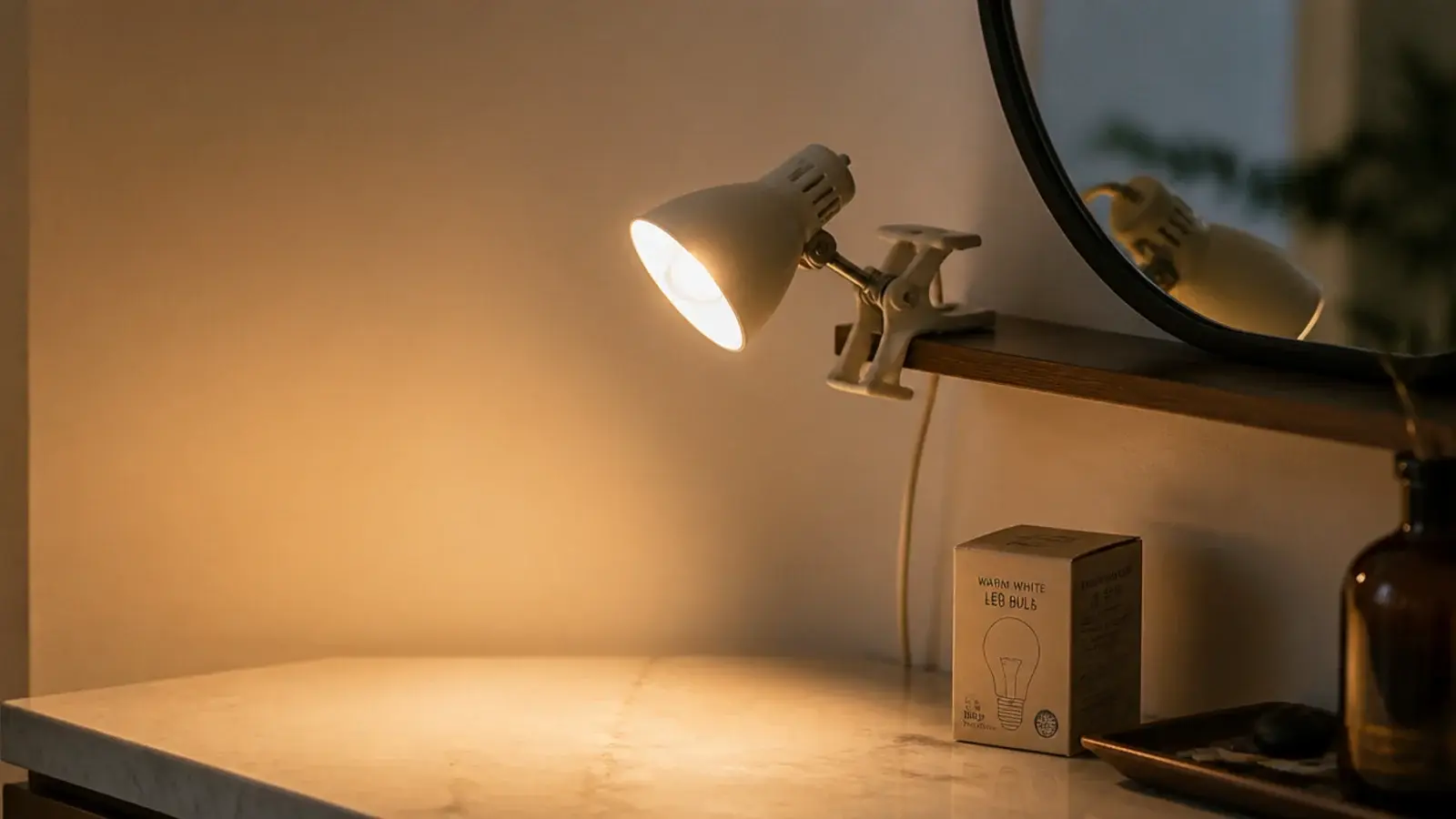 clip on lamp with a warm bulb lighting a vanity mirror from the side