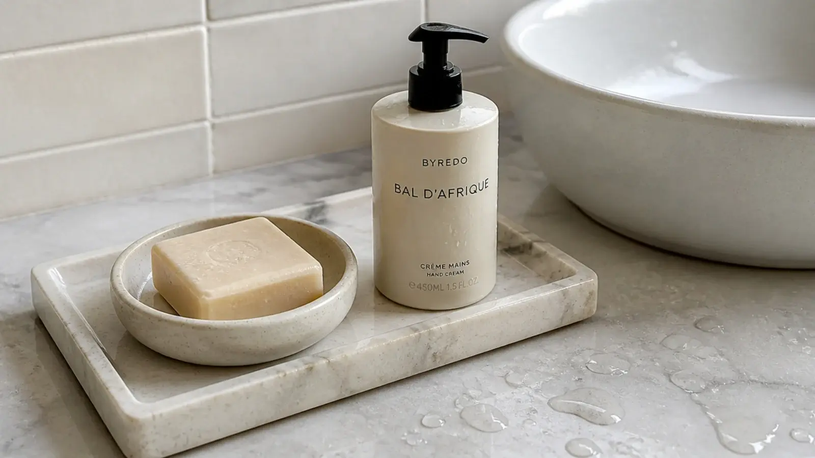 marble tray holding soap and hand cream beside a bathroom sink