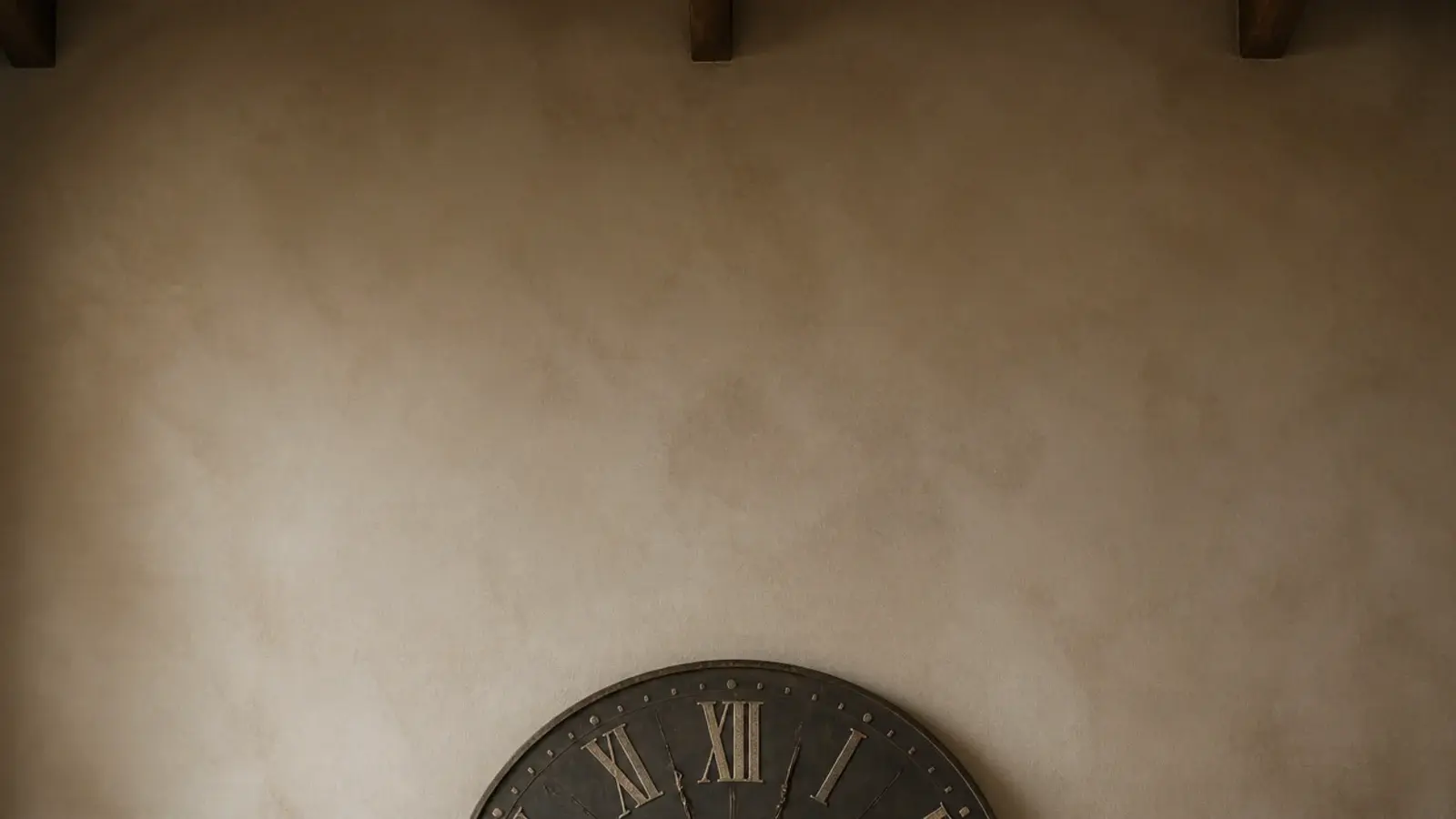 tall wall showing an oversized clock above a long low sideboard