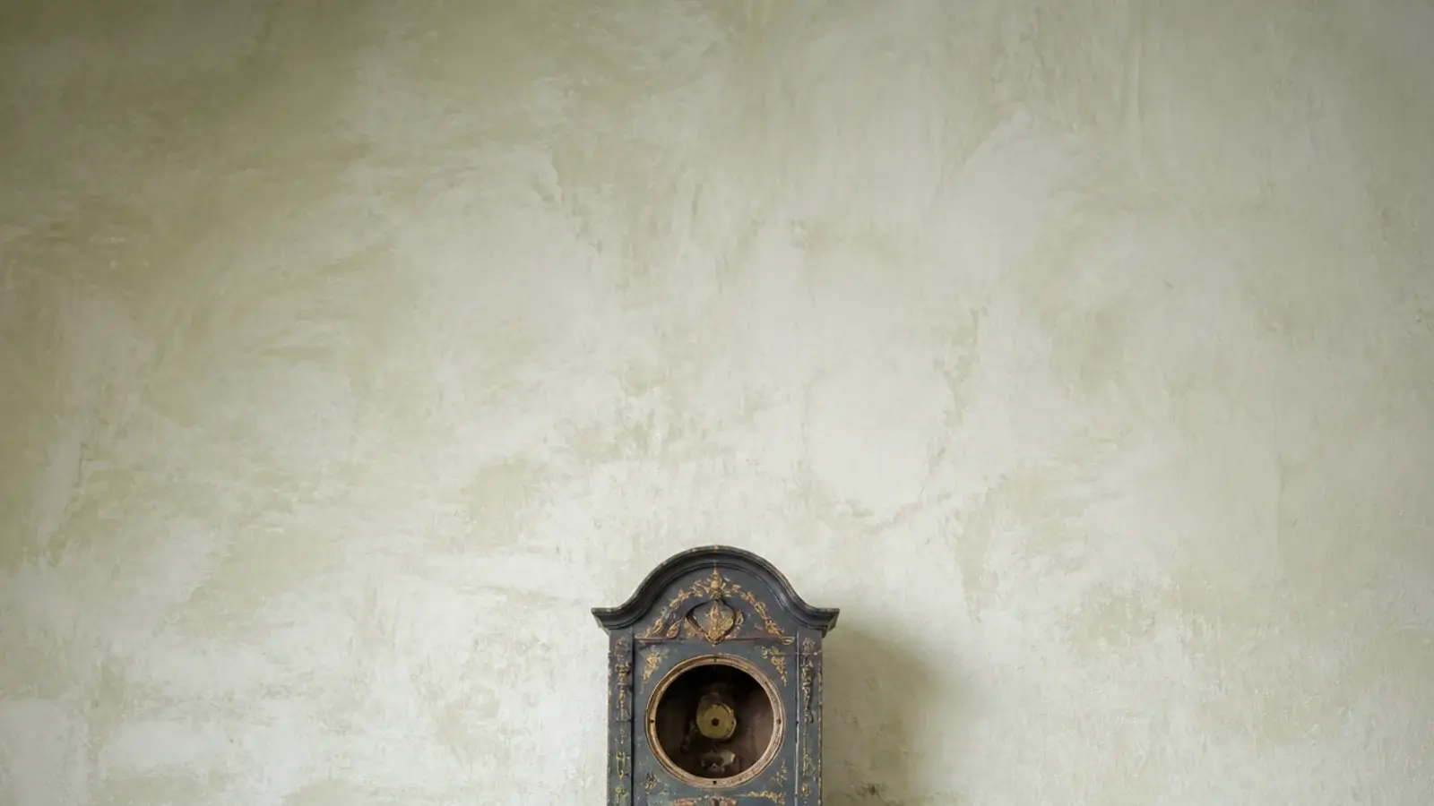 tall stack of thrifted vintage clocks waiting to be restored