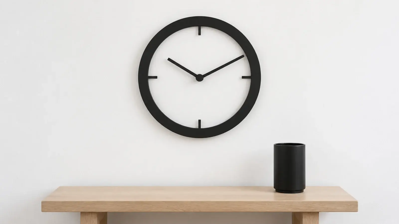 thick black ring clock on a white wall with no visible case