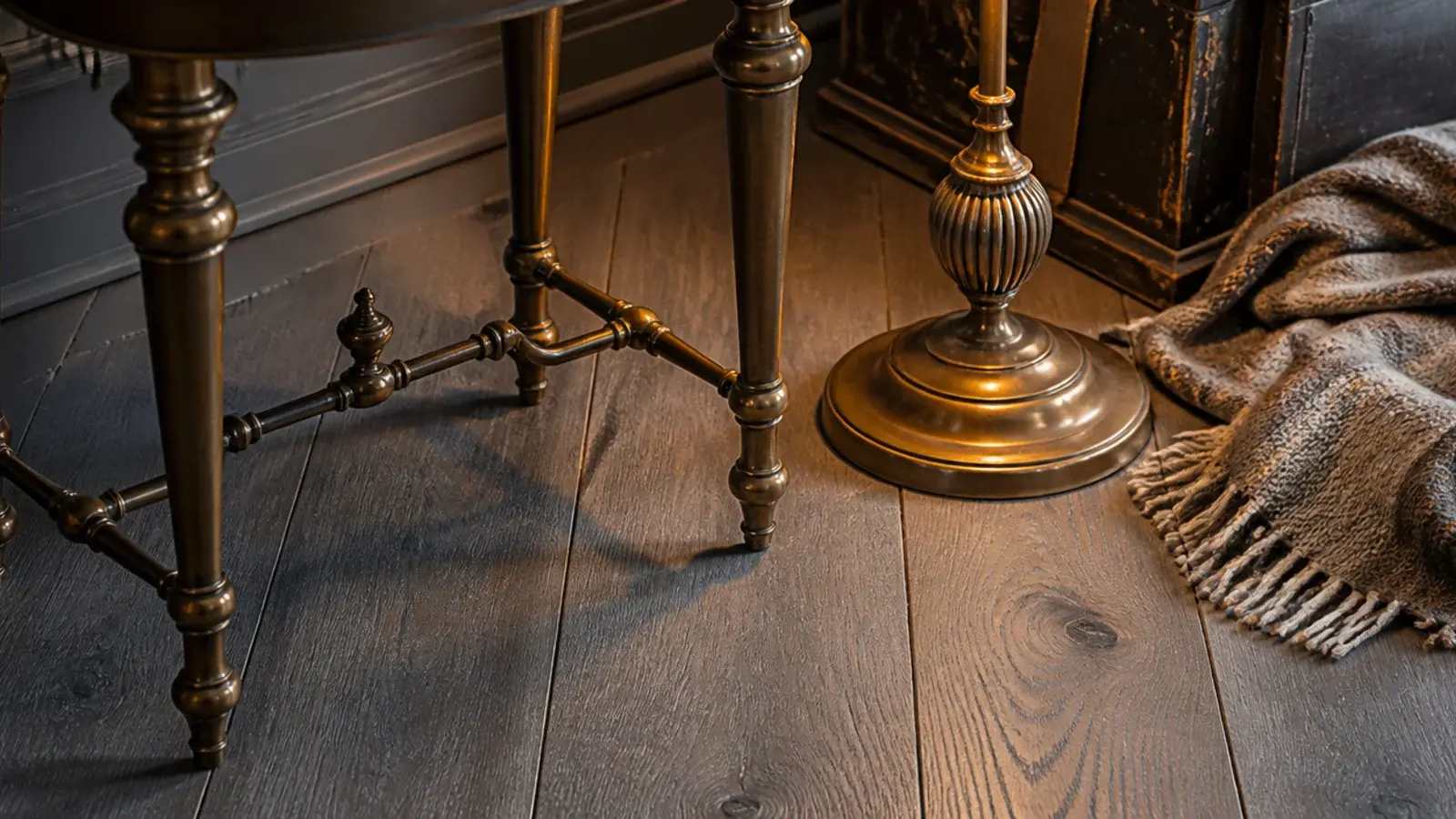 aged brass table legs and lamp base standing on grey oak boards