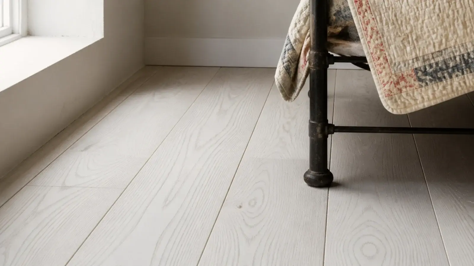 whitewashed pine boards with grain showing through thin white pigment