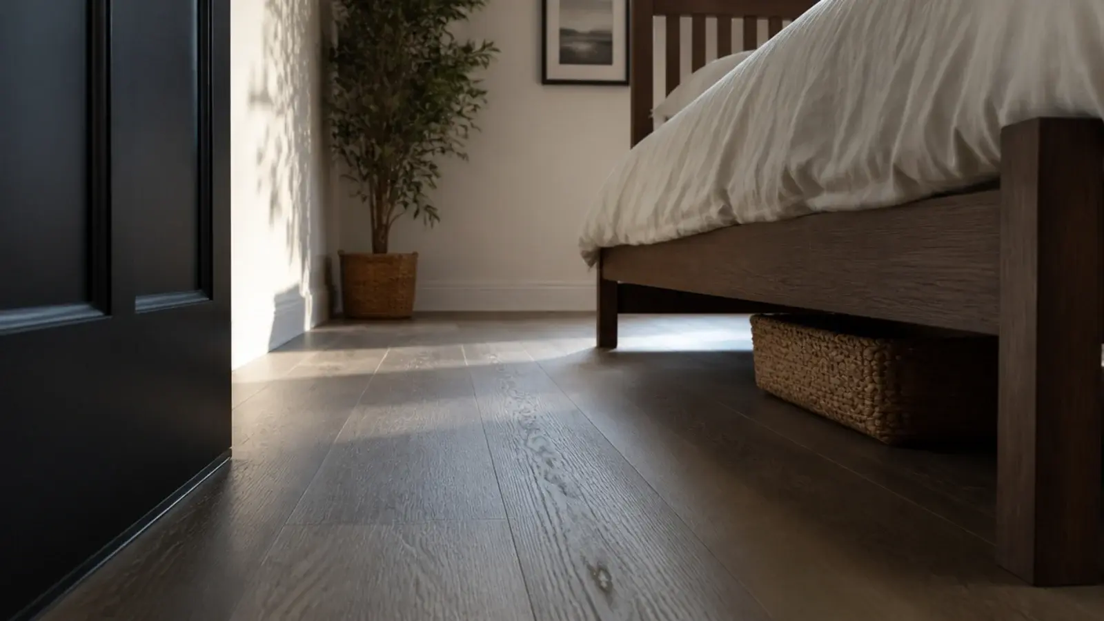 floorboards running unbroken beneath a bed frame to the far wall