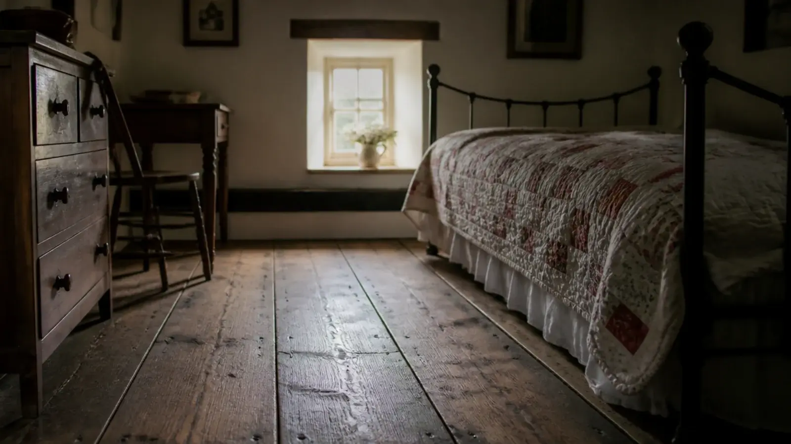 wide reclaimed pine boards with old nail marks in a cottage bedroom