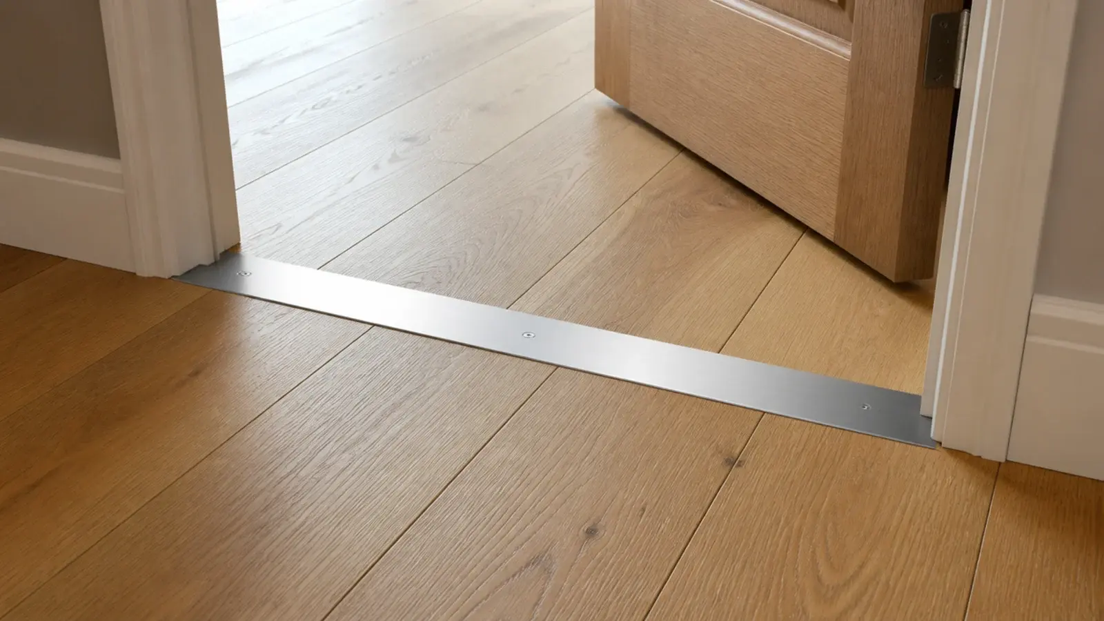 flush metal threshold strip set level between two timber floor areas
