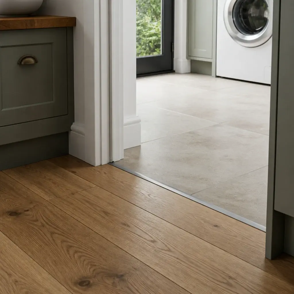 timber kitchen boards meeting porcelain tile at a utility doorway