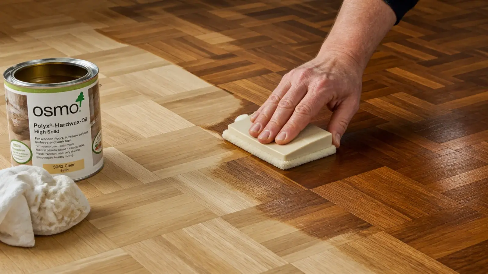 hardwax oil being worked into freshly sanded parquet with a pad