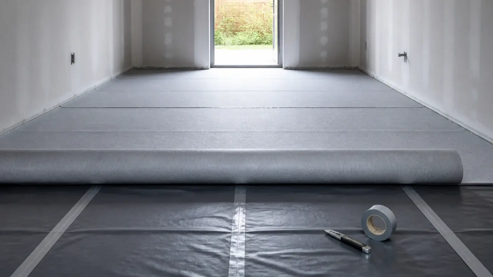 damp proof membrane and foam underlay rolled across a concrete floor