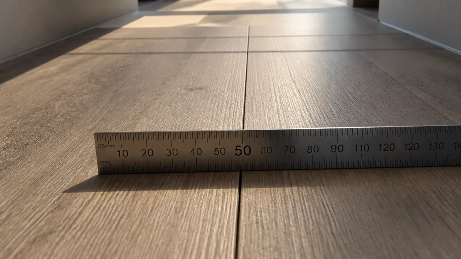 rectified plank tiles meeting in a very narrow precise grout line