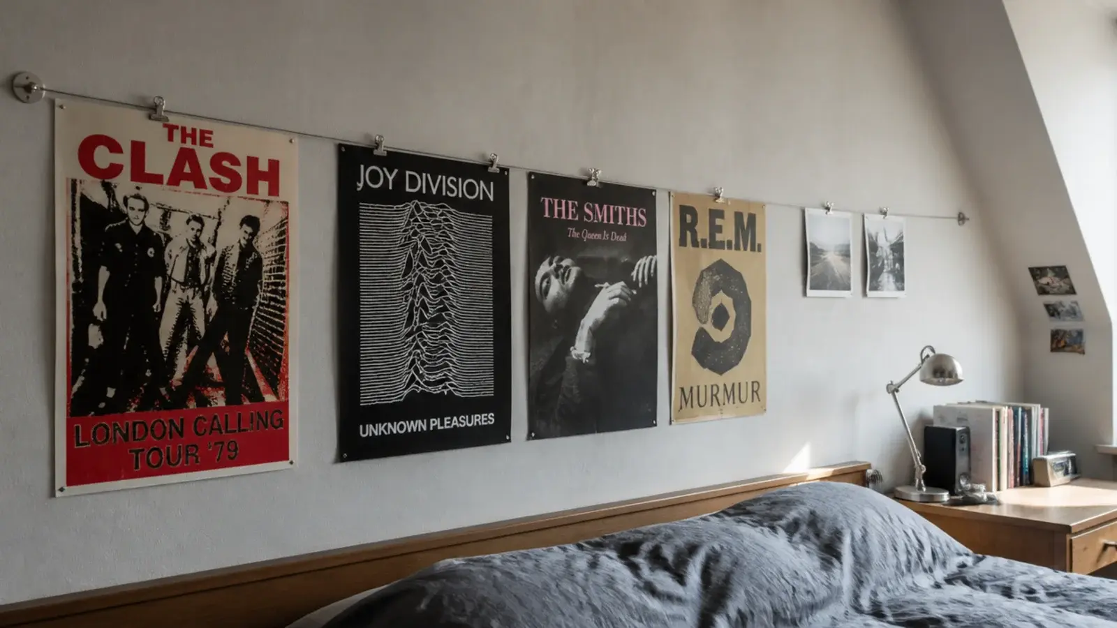 posters clipped to a taut wire strung across a teenage attic wall