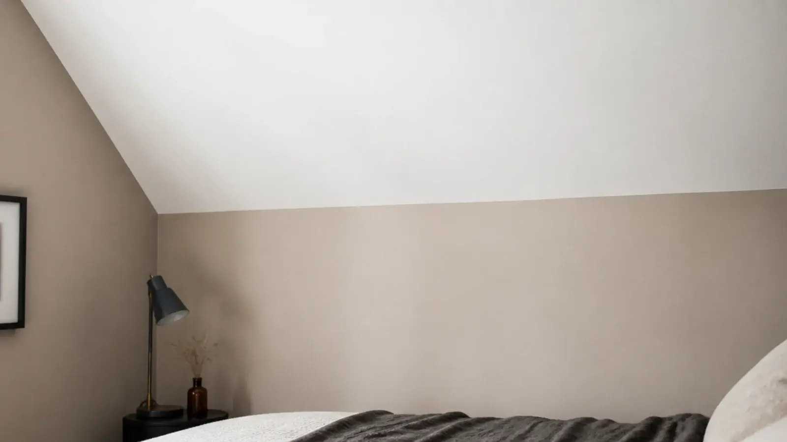 visible line where a bright ceiling meets a softer painted attic wall