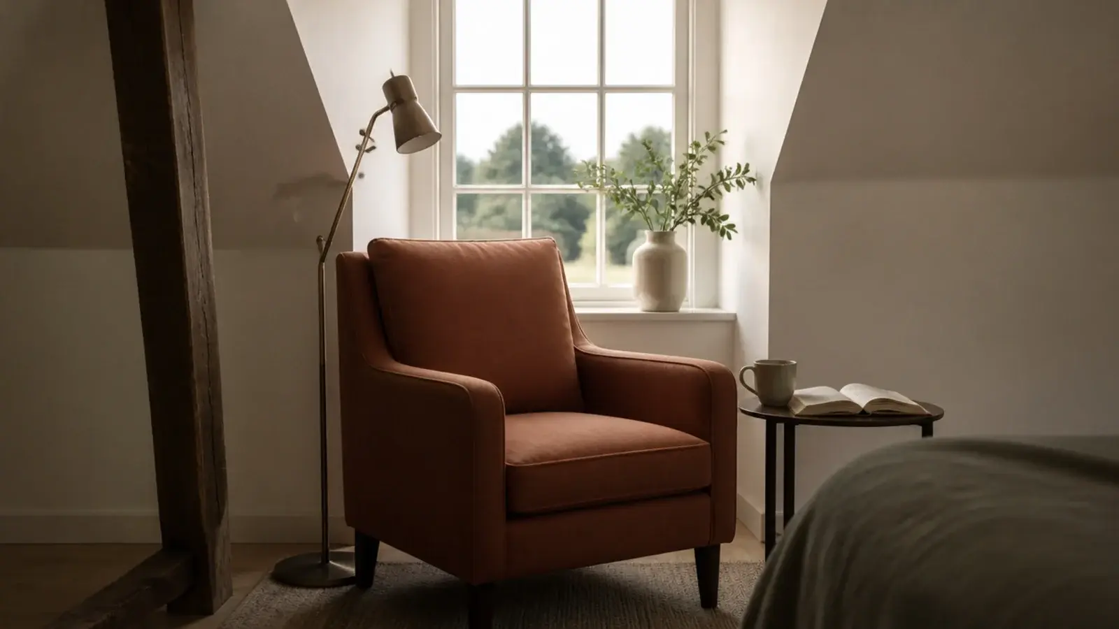 armchair and floor lamp filling the square recess of a loft dormer