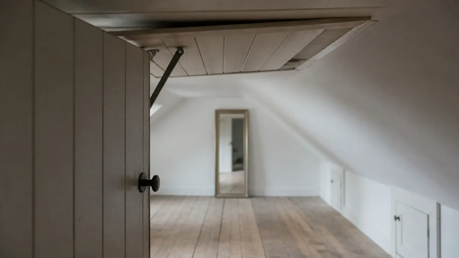attic doorway opening directly into the tallest strip of the room