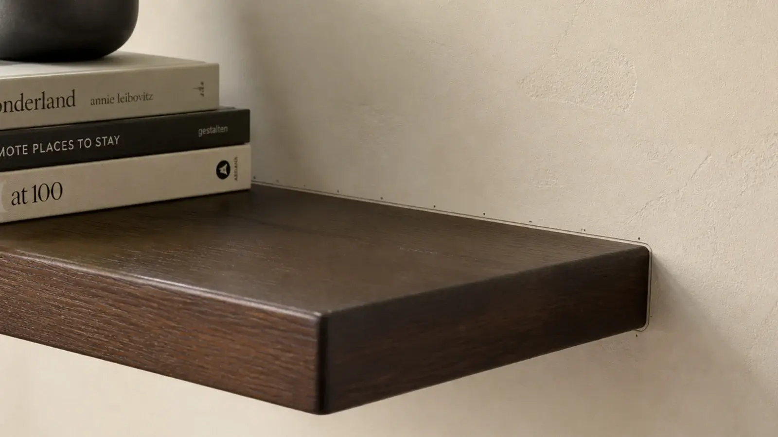 thick shelf on hidden rod brackets appearing to grow from the wall