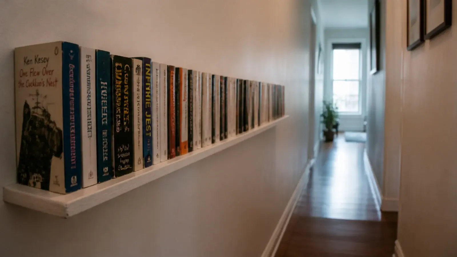 six inch floating ledge of paperbacks running along a hallway wall