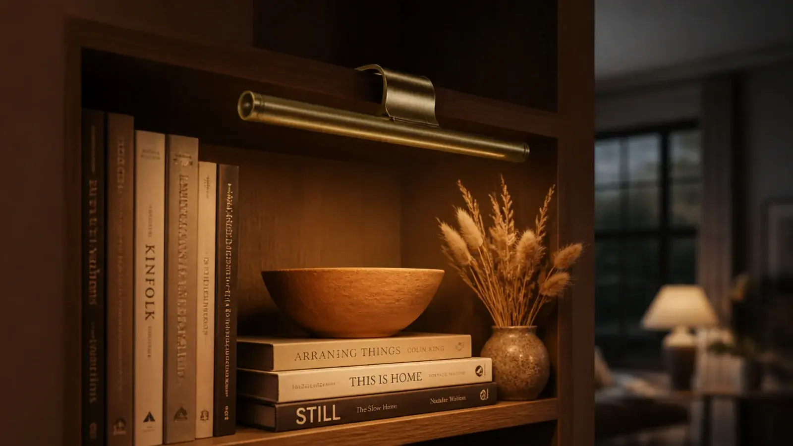 brass rechargeable picture light lighting styled built-in shelves at dusk