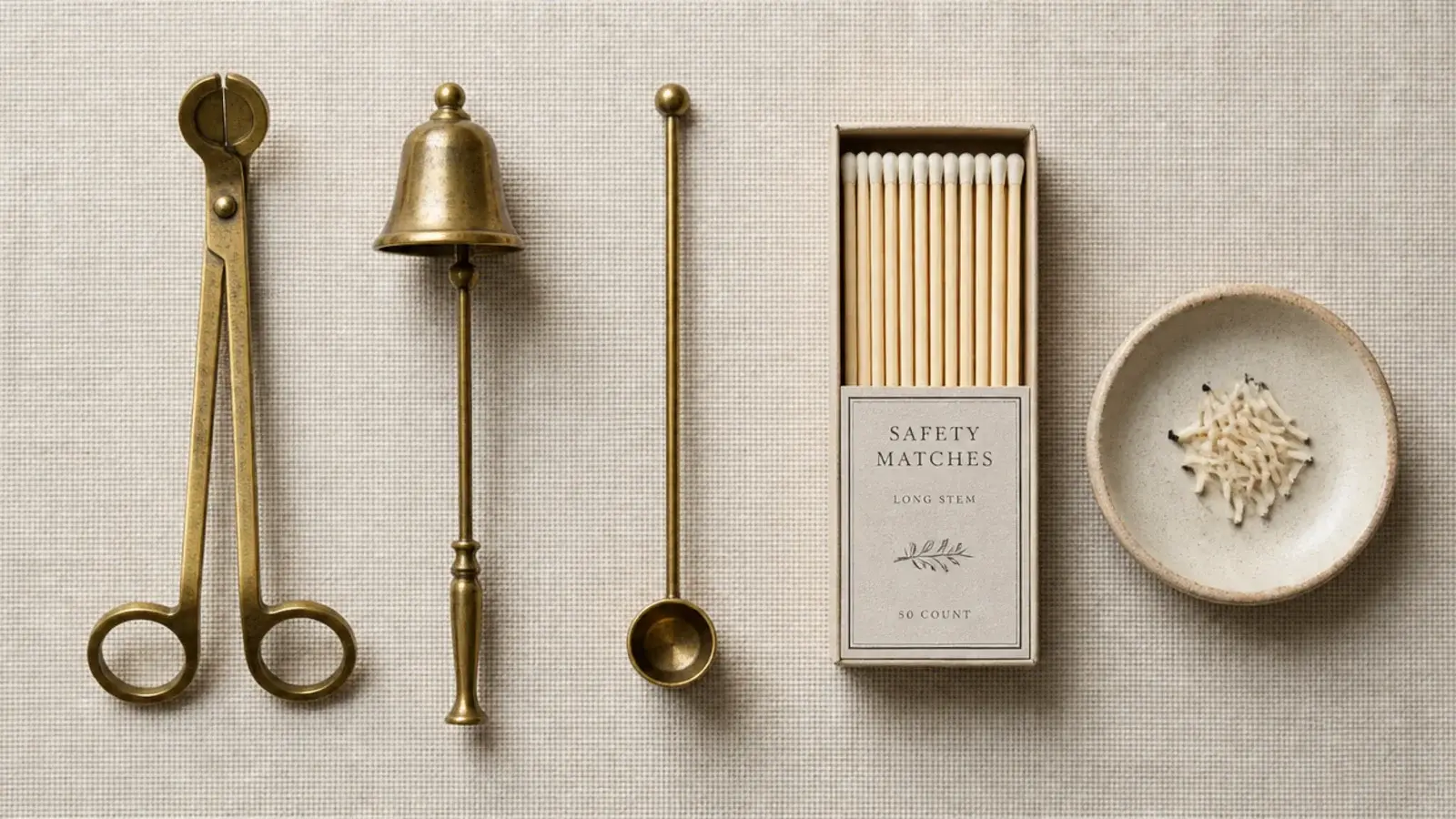 wick trimmer snuffer and matches arranged in a small candle care dish