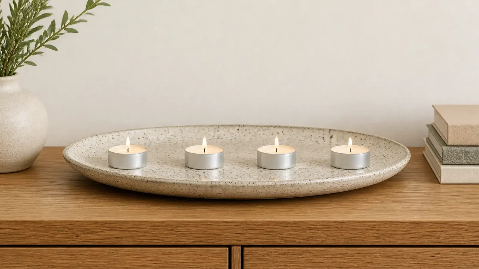 tealights spaced evenly across a wide stoneware plate with clear gaps