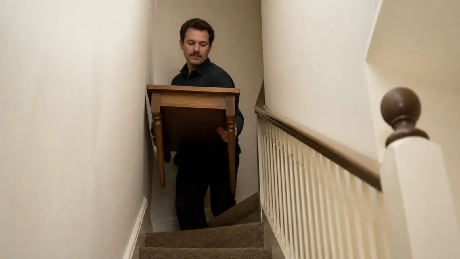 compact table being carried up a narrow rented staircase easily