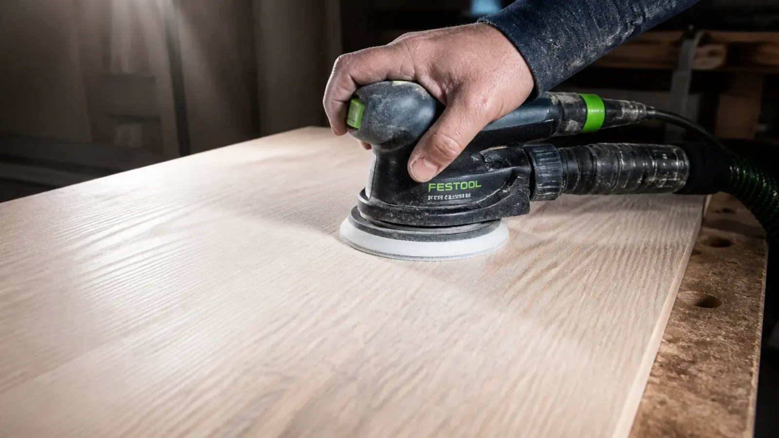 random orbit sander levelling the glue lines across a timber panel