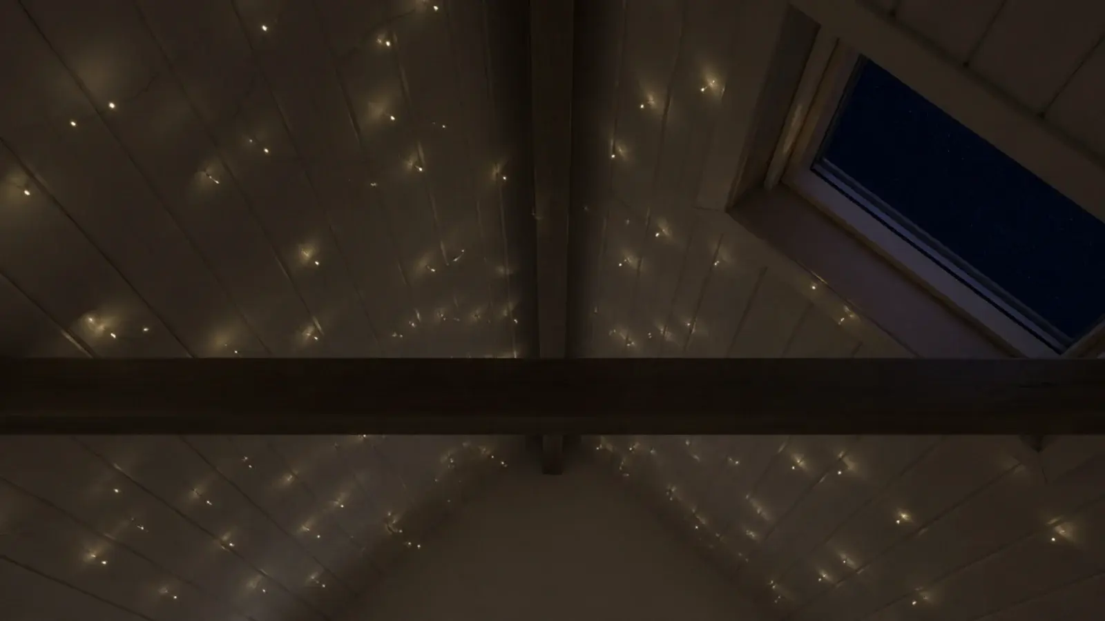 irregular scatter of tiny lights across a sloped bedroom ceiling