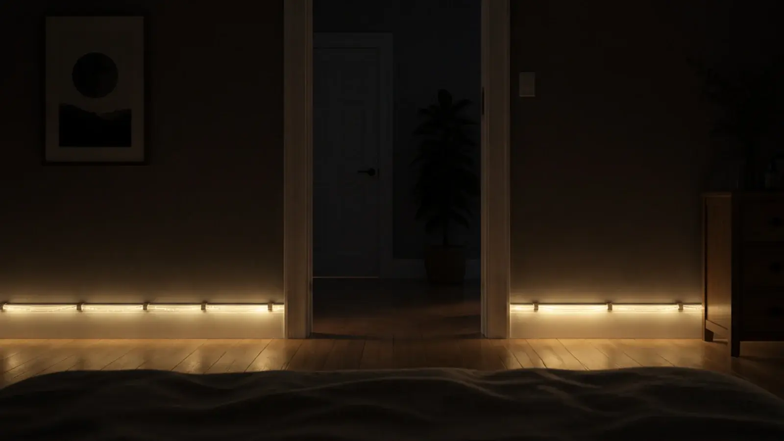 warm light line running along skirting board in a dark bedroom