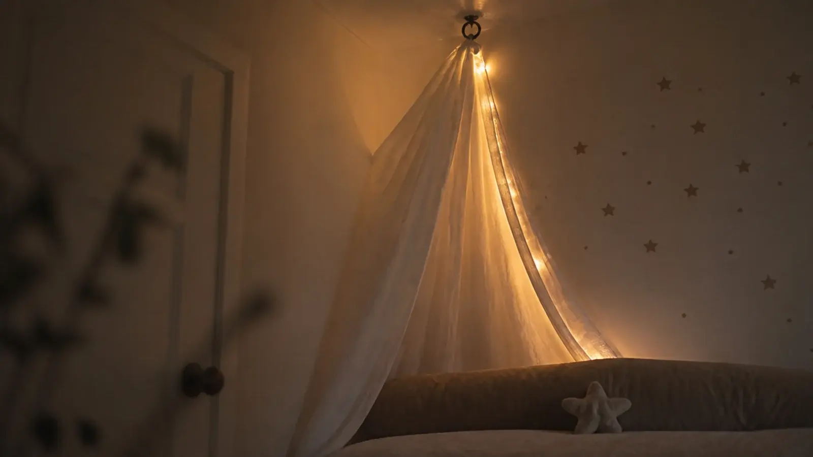 corner of a bed canopy where fabric and lights meet the wall