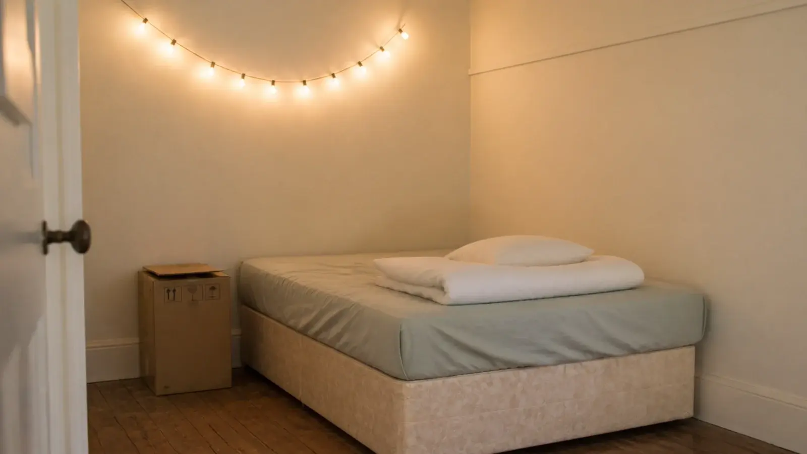 simple fairy lights bedroom run clipped along a plain rented wall