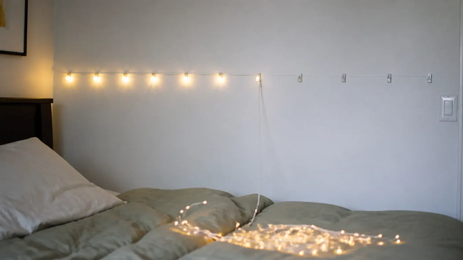 how to hang fairy lights in bedroom shown along a marked wall line