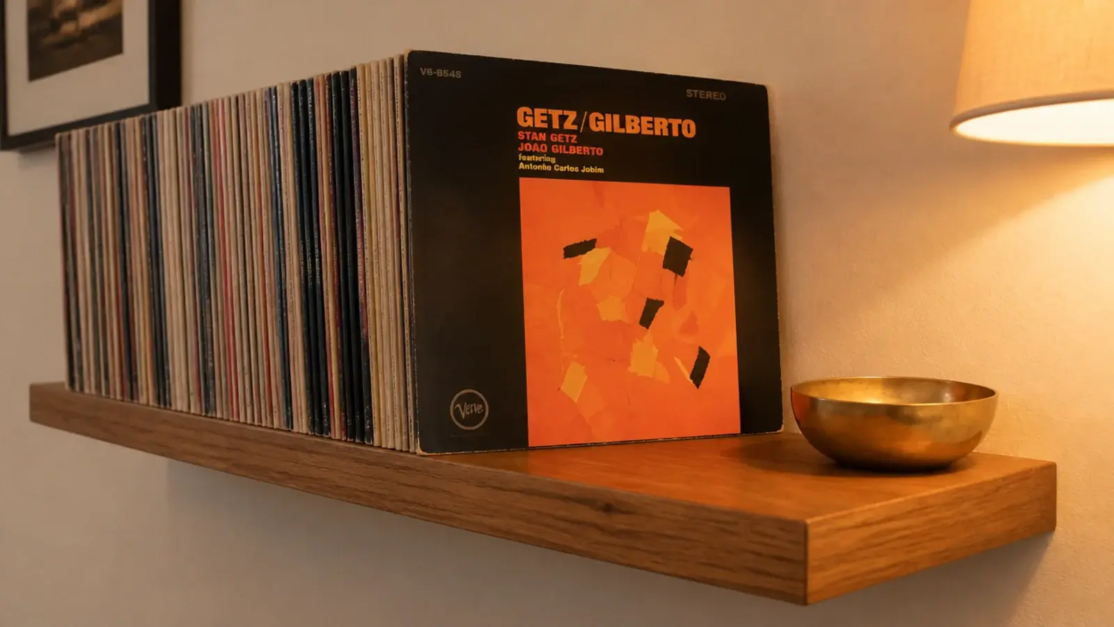 floating shelf holding vinyl records with one album leaning cover out