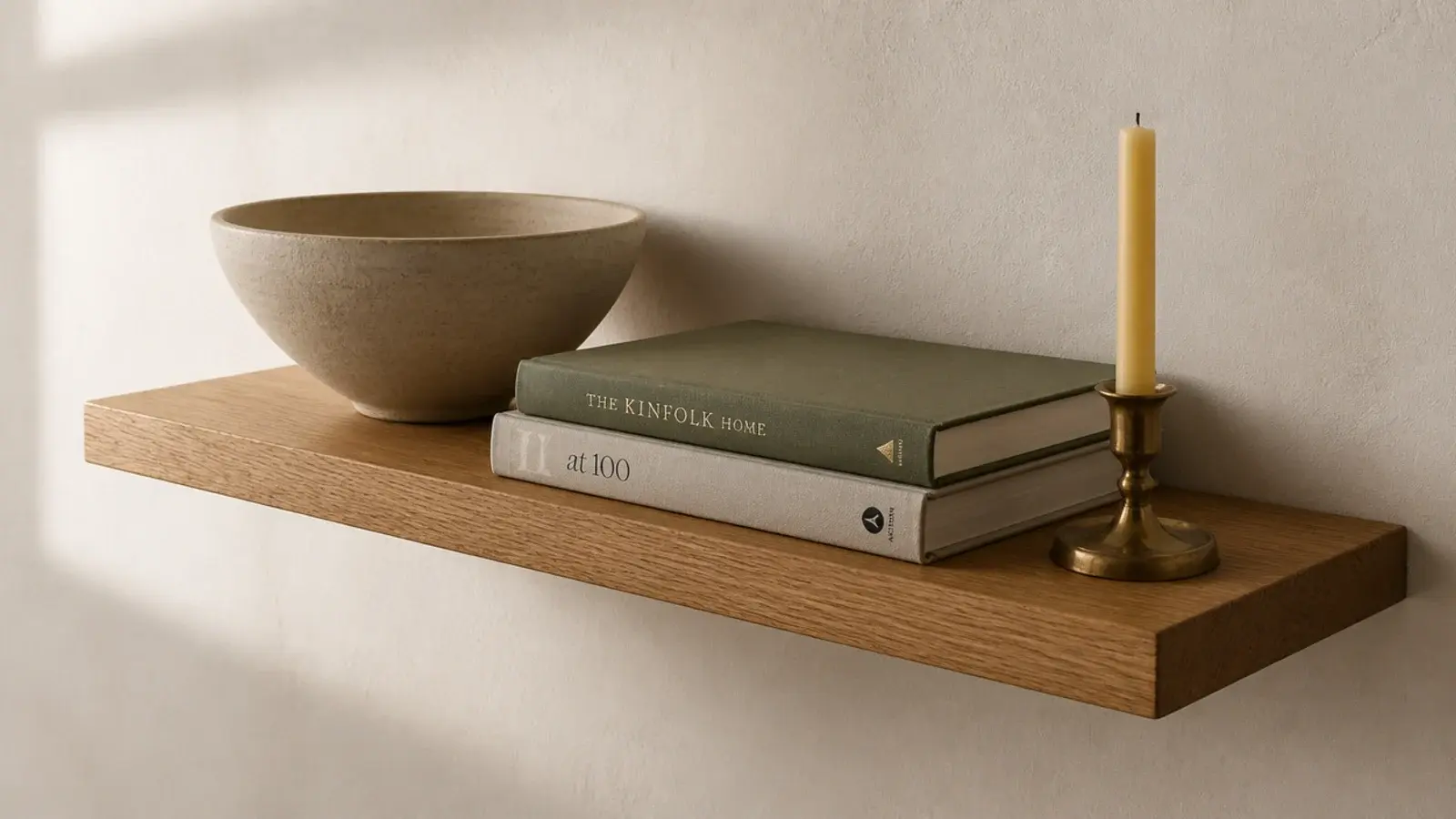 single 24 inch oak floating shelf mounted level on a plain cream wall