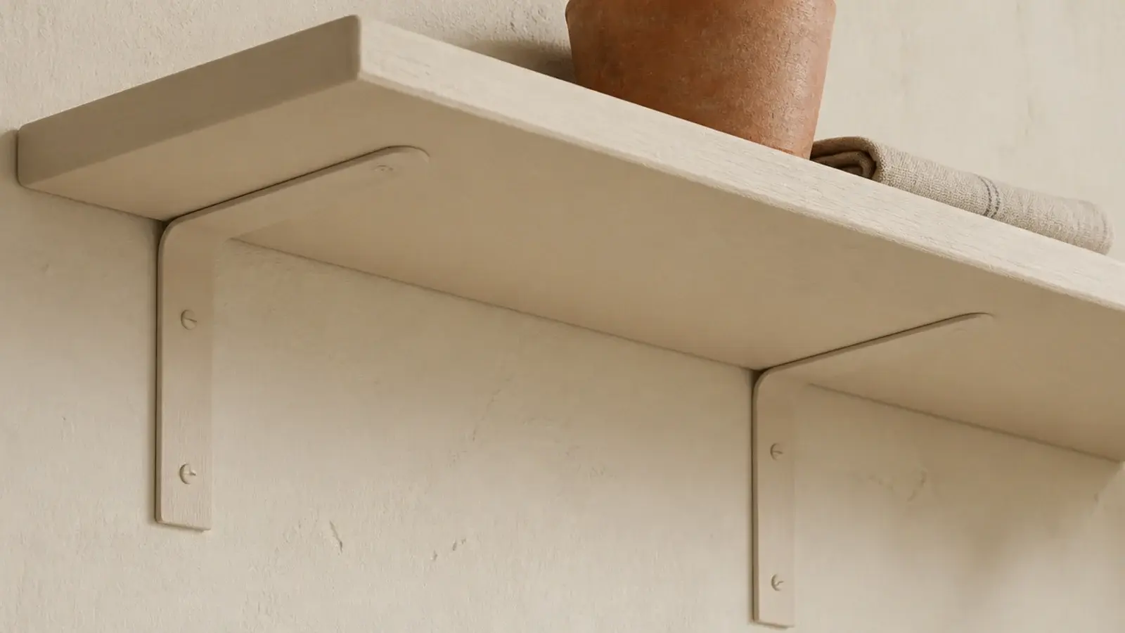 pine shelf on cream painted L brackets that disappear against the wall