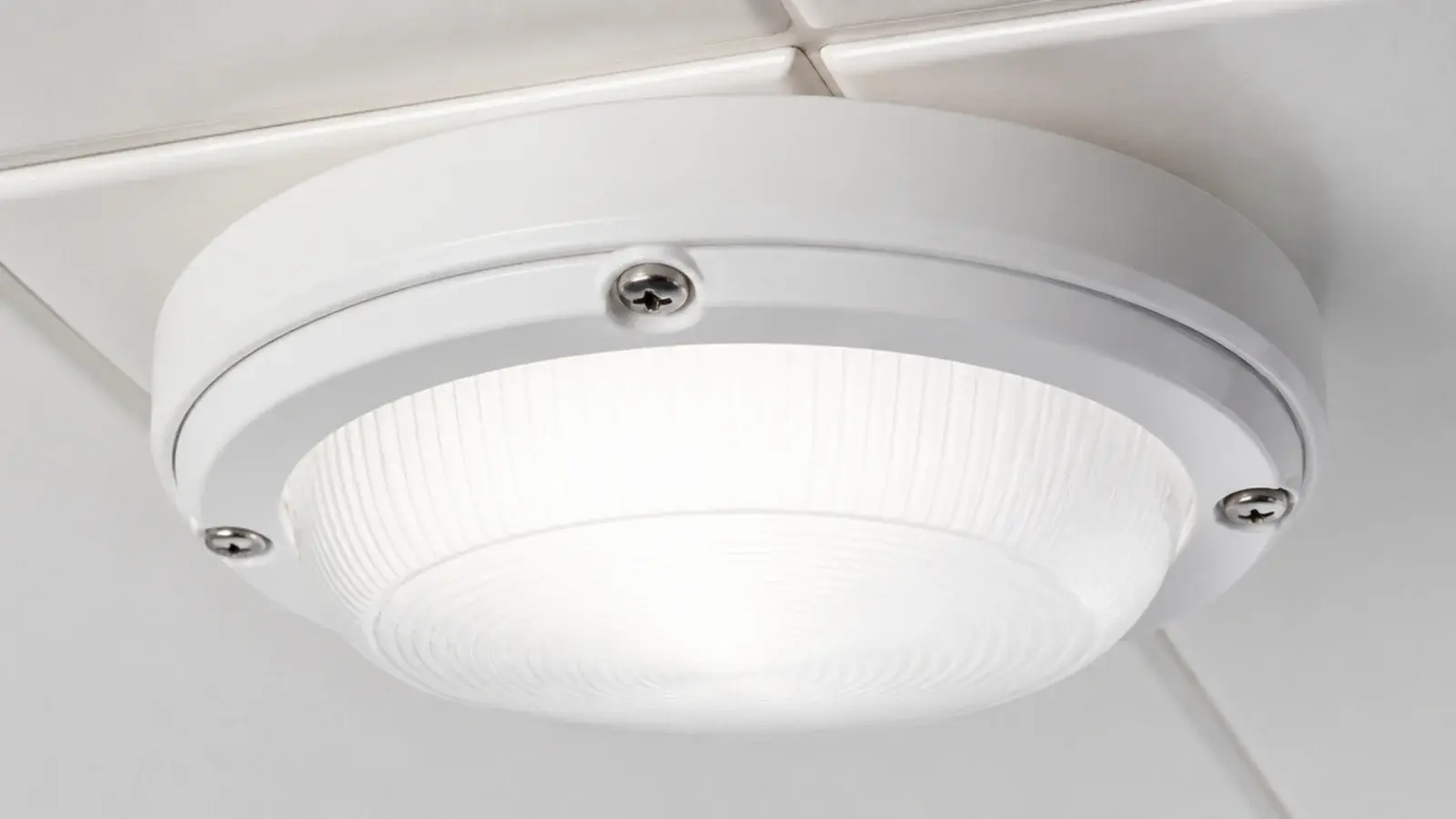 gasket seated evenly around a closed bathroom light fitting