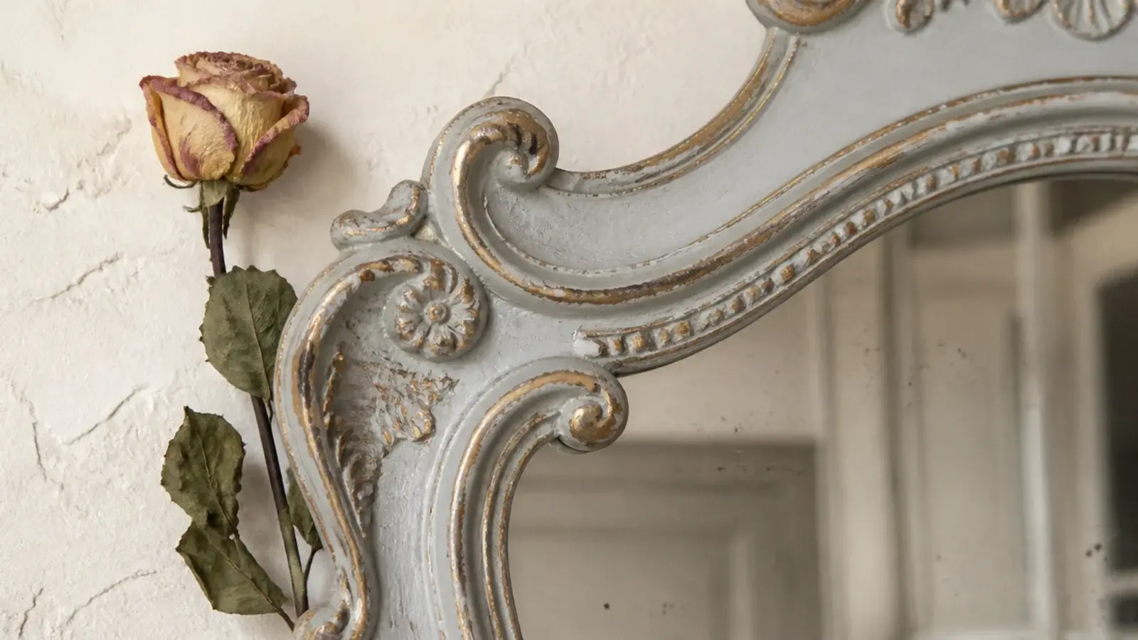distressed grey painted French mirror frame with gilt showing through