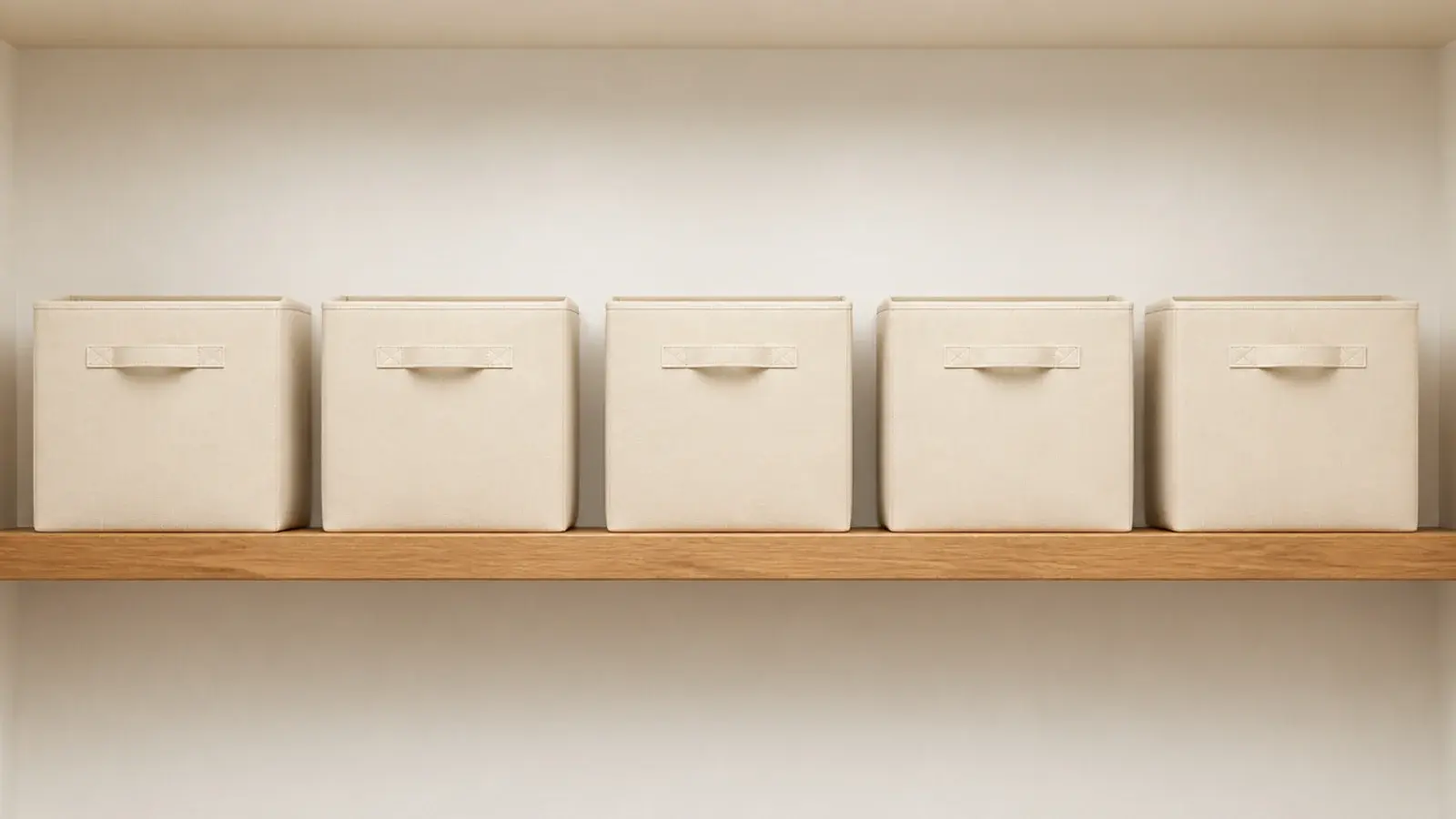 row of identical canvas bins on a minimalist closet top shelf