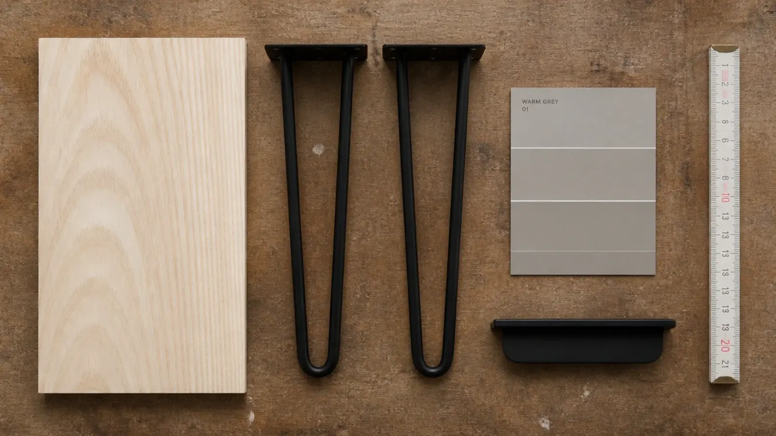 flat lay of ash board sample black legs paint chip and edge pull