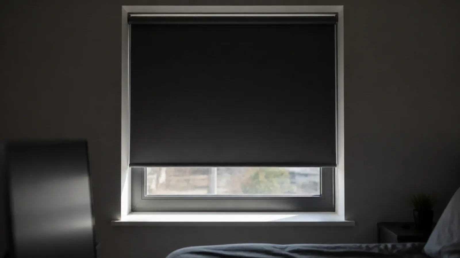 charcoal blackout blind fitted tight inside a bedroom window reveal